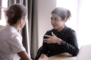 women at work listening to each other to build culture of compassion