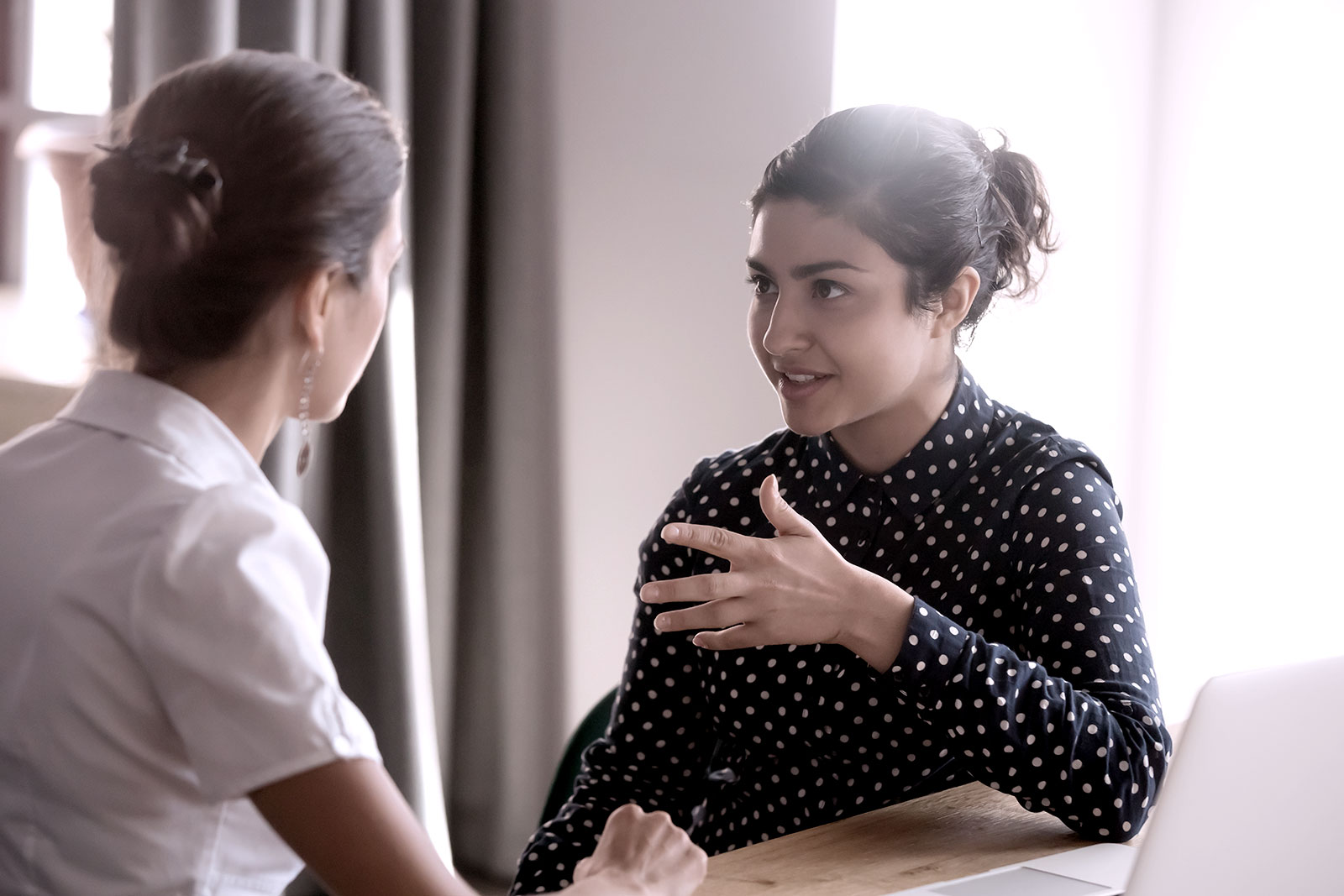 women at work listening to each other to build culture of compassion