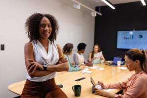 Portrait of happy biracial casual businesswoman in meeting room